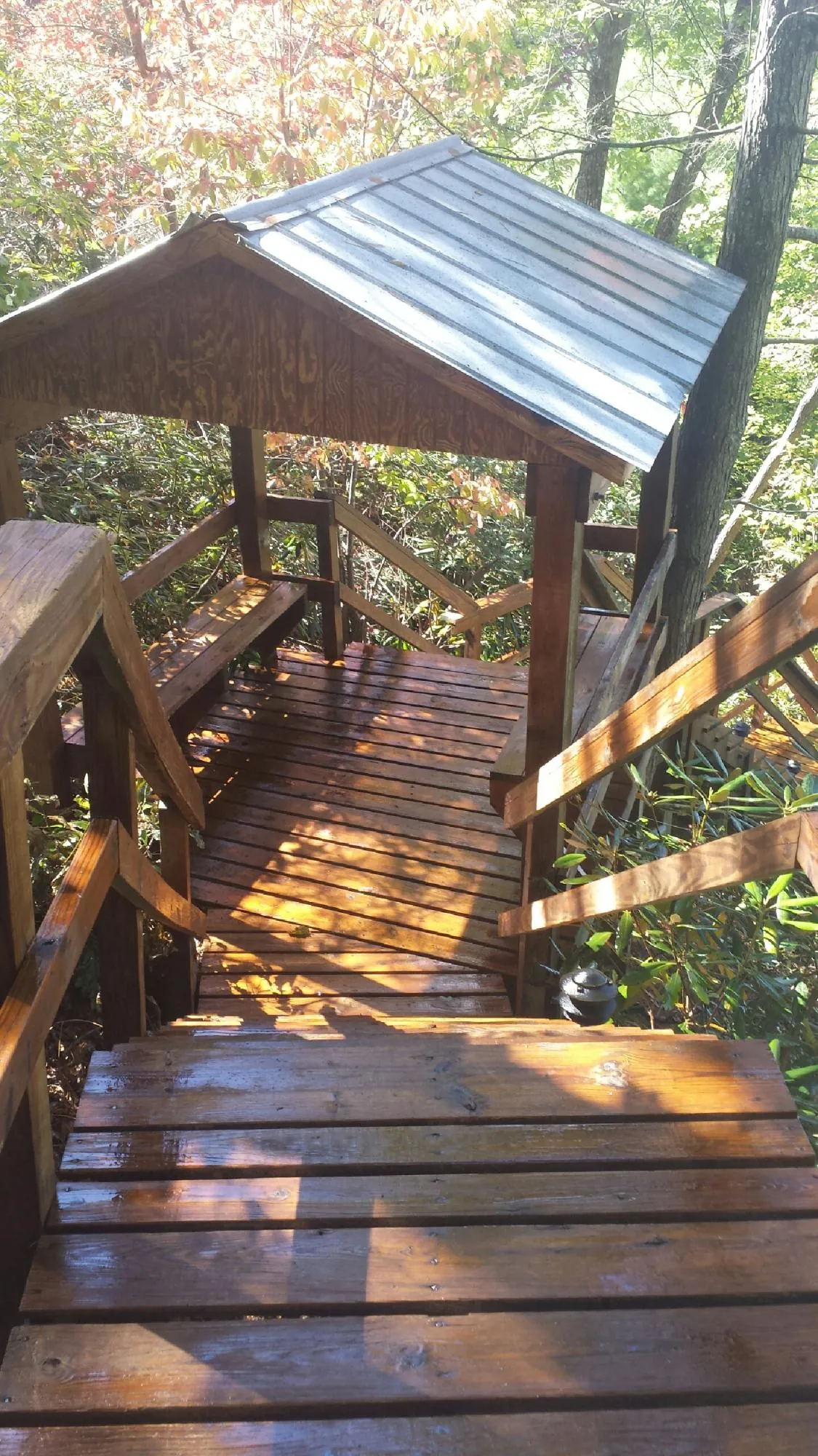 Freshly stained wood walkway and covered shelter with a metal roof in Collettsville