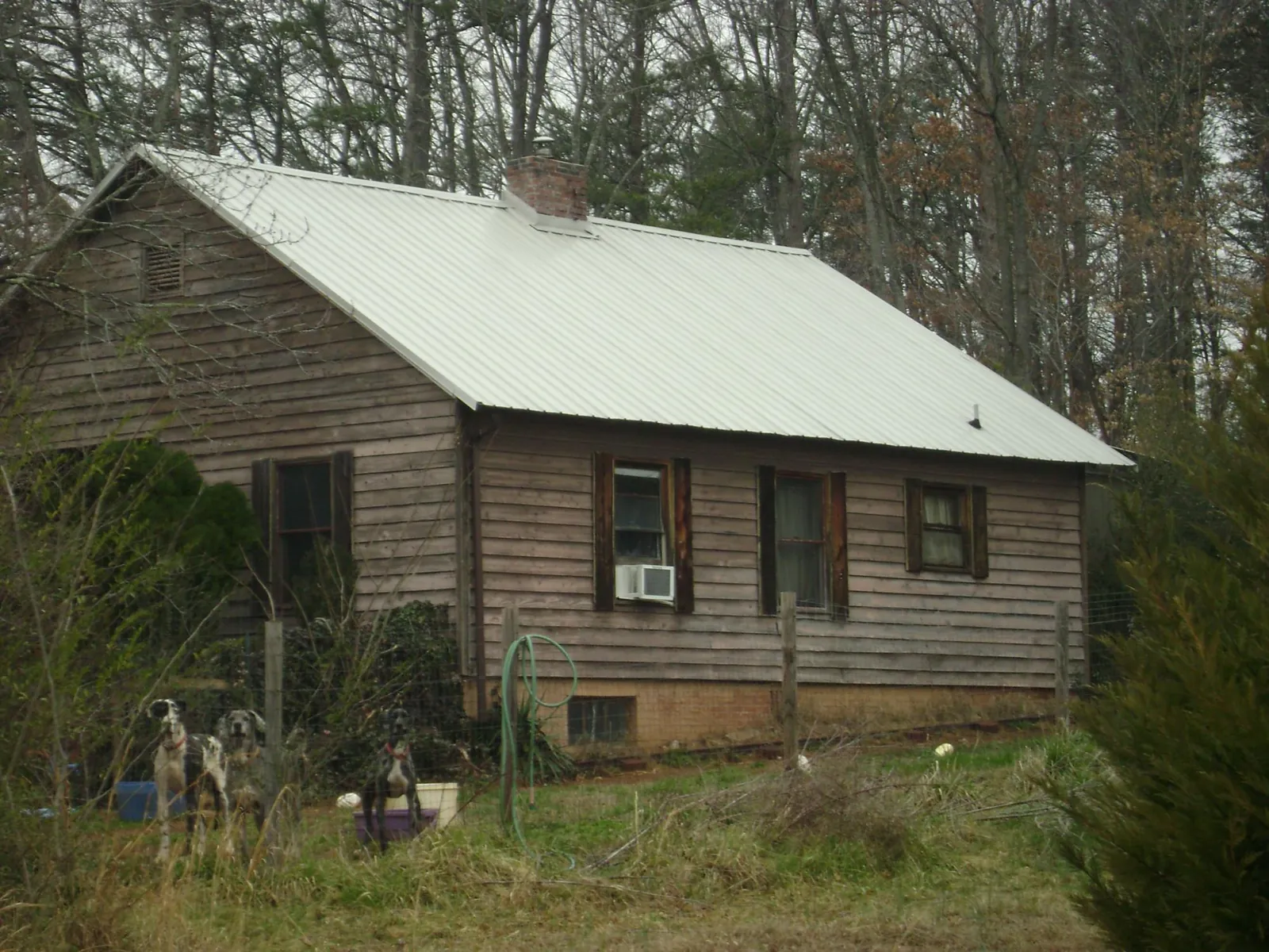 White metal roof on an old wood sided farmhouse, from a Metal Roof Installation job in Collettsville